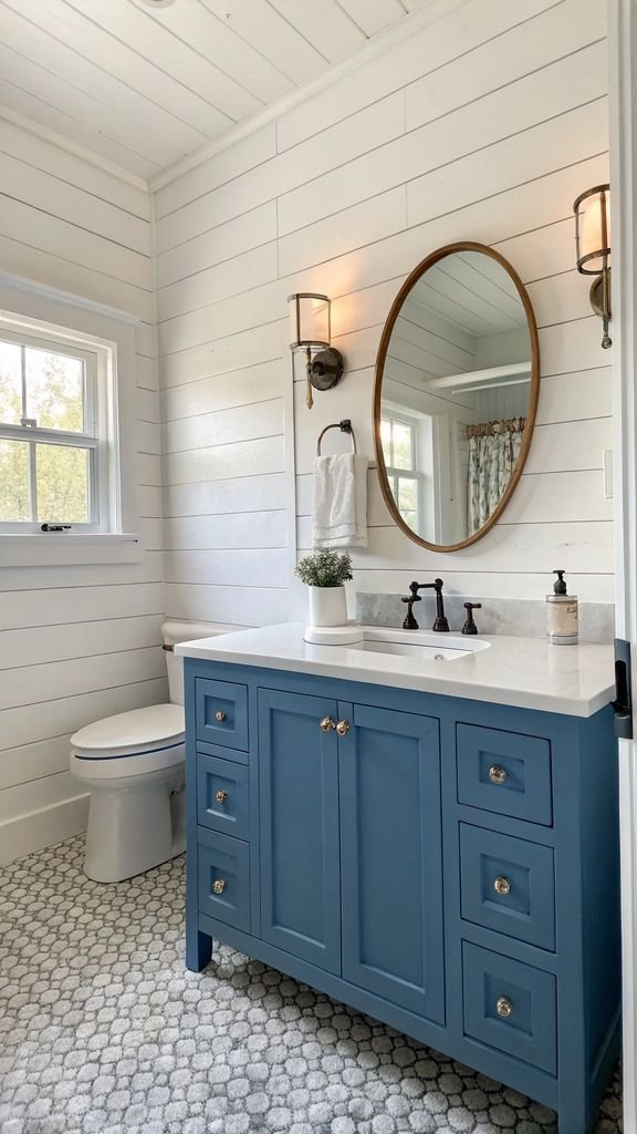 a bathroom with white shiplap walls and a blue vanity.